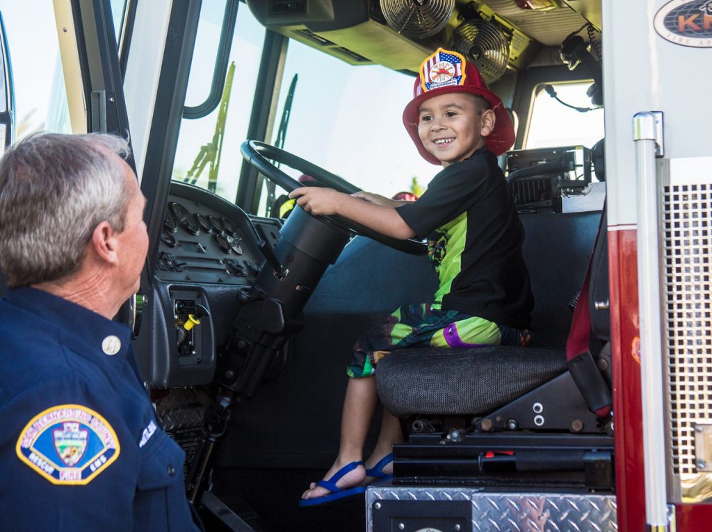 Child in drivers seat of fire truck