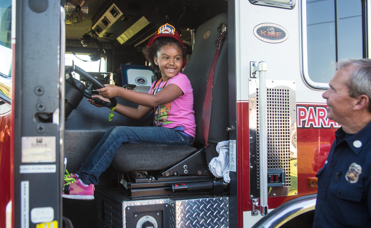 Girl in drivers seat of fire truck